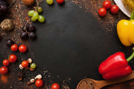 Healthy rustic food recipe frame top view. Tasty background with variety of vegetables and spices, free space. Cuisine and menu conceptの写真素材