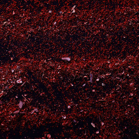 Messy spicy background. Spice texture close up top view. Variety of red spices on table, curry and herbs. National eastern cuisineの写真素材