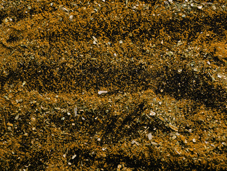 Messy spicy background. Spice texture close up top view. Variety of yellow spices on table, curry and herbs. National eastern cuisineの写真素材