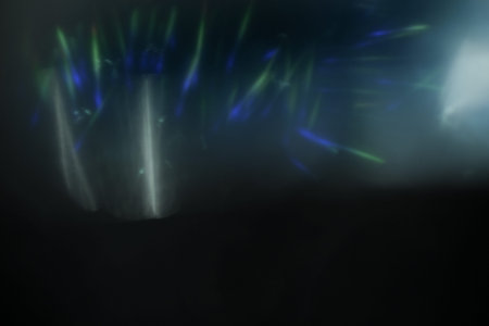 Real Lens flare light effect. Sparkle ray leak on black background. Optical effect of spotlight....
