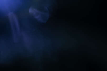 Real Lens flare light effect. Sparkle ray leak on black background. Optical effect of spotlight. Flash leak beam.の写真素材