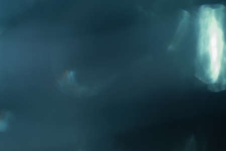 Real Lens flare light effect. Sparkle ray leak on black background. Optical effect of spotlight. Flash leak beam.の写真素材