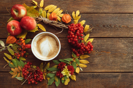 Autumn harvest. Fall leaves and berries assortment background. Hot beverage concept
