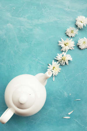 Herbal tea and chrysanthemums on a blue background. Healthcare lifestyle. Pure and tenderness.の写真素材