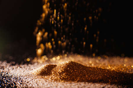 Shimmering abstract gold background. Flowing glitter. Rich and luxury conceptの写真素材