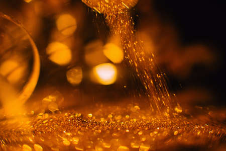 Festive abstract gold glitter defocused background. Blur bokeh lights. Christmas holidays celebration. Family and unity conceptの写真素材