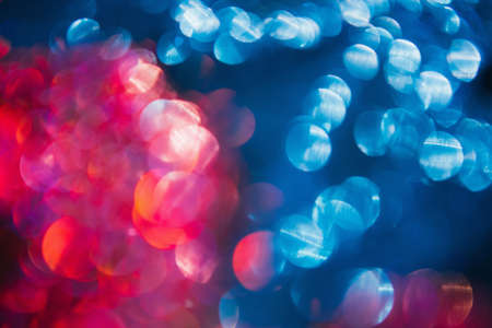 New year festive bokeh blur background. Rain on the window. Colorful abstract lights conceptの写真素材