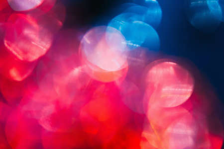 New year festive background. Defocused bokeh blur lights. Colorful abstract city flares conceptの写真素材