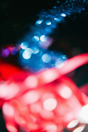 Festive holiday abstract background. Multicolor blur ribbons and shiny glitter conceptの写真素材
