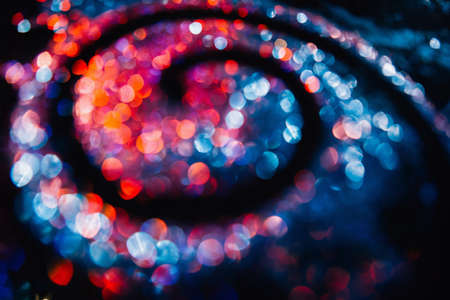 Colorful glitter swirl background. Blurred image of Milky Way galaxy on contrast black background conceptの写真素材