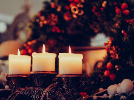 christmas eve attribute wreath home coziness concept. candles light. comfort lifestyleの写真素材