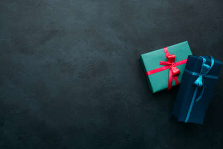 Two gift boxes on dark background. Problem of choosing a perfect gift for a man. A worthy reward conceptの写真素材