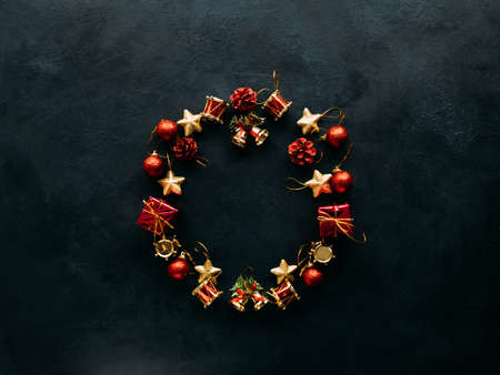 Christmas wreath of toys on dark background. Atmosphere of winter holidays.の写真素材