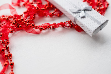 jewelry present in closed gift wrapping box on white background. great surprise for women on birthday, valentines day, new year, christmas, mothers day and other holidays.の写真素材