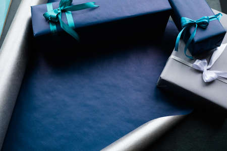 expensive luxury present for rich men on dark background. professional gift wrapping. worthy surprise for bithday, fathers day, valentines day, new year, christmas, thanksgiving and other holidays.の写真素材