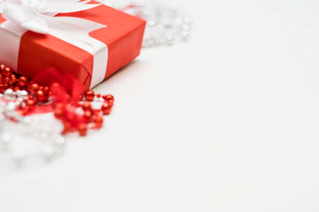 luxury jewelry present for women on white background. red closed gift box with wrapped ribbon. expensive surprise for women day, mothers day, valentines day, new year, christmas, and other holidays.の写真素材