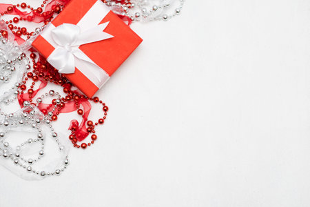 luxury jewelry present for women on white background. red ribbon wrapped gift box. expensive surprise on women day, mothers day, valentines day, new year, christmas, thanksgiving and other holidays.の写真素材