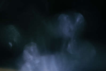Real Lens flare light effect. Sparkle ray leak on black background. Optical effect of spotlight. Flash leak beam.の写真素材