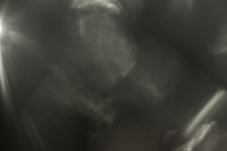 Real Lens flare light effect. Sparkle ray leak on black background. Optical effect of spotlight. Flash leak beam.の写真素材