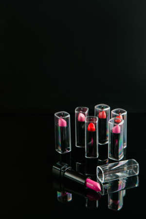 wide selection of womens lipsticks on black background. beauty blog. professional make-up courses. free space conceptの写真素材