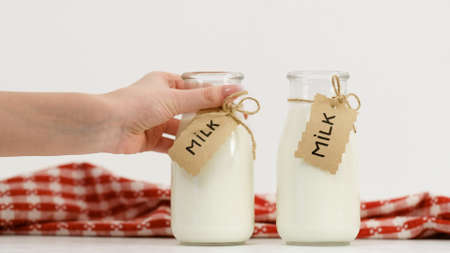 milk bottle on white background. Healthy dairy products. Natural drink for proper nutrition. Lactose, amino acids and protein source. Copyspace conceptの写真素材