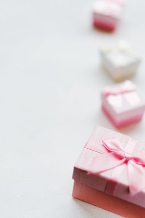Girl gift on Valentines Day. Lovely surprise. Pink festive present boxes on white background. Free...