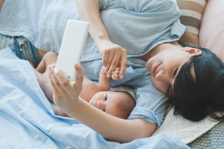 family communication chat smartphone newborn concept. say hi to daddy. family online conversation. together despite the distanceの写真素材