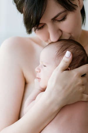mothers love tenderness kiss newborn baby concept. family values. moments of happiness.の写真素材