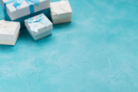 Presents in gift boxes on blue background. Holiday or birthday reward. Festive celebration. Copy space conceptの写真素材