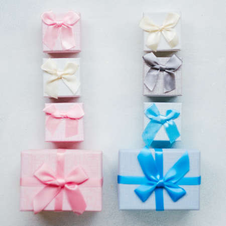 Blue and pink gift boxes on white background top view. Present choosing for opposite genders. Boy and girl differenceの写真素材