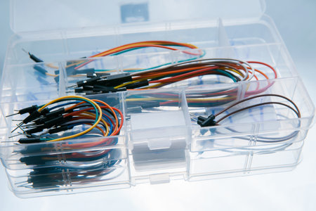 Box with jump wires cables on white background. Electronics repair. Construction kitの写真素材