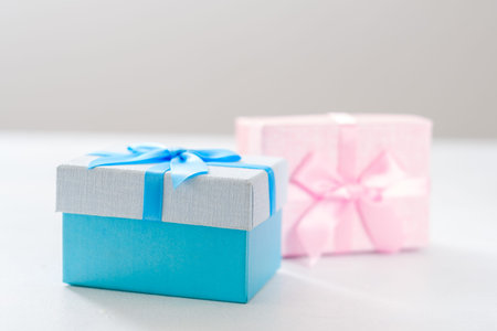 Gender presents for kids. Blue and pink gift boxes on white background. Holiday celebration.
