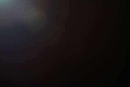 lens flare. abstract light effect. glow on black backdrop. sun rays sunlightの写真素材