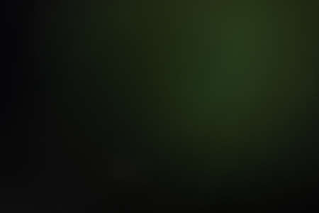 blurred glowing green light. lens flare. soft shine dark backgroundの写真素材