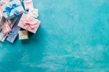 assortment of gift boxes on blue background. consumerism sale discount. present shopping. holiday festive season. copy space conceptの写真素材
