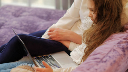 family leisure. mom and daughter watching video or movie together on the laptop. computer technology conceptの写真素材