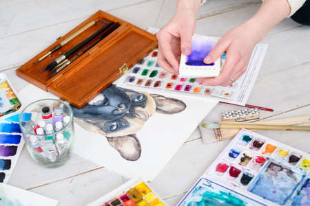 art painting inspiration creativity concept. artist creations. watercolors and drawings color swatches and brushes scattered on the floorの写真素材