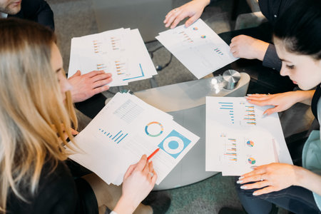 office meeting. business team brainstorming. group of workers study documents with graphs and diagrams. information analysisの写真素材