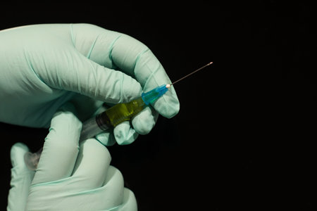 medicine health pharmacy illness. nurse hands in latex gloves holding syringe with vaccine or serum...