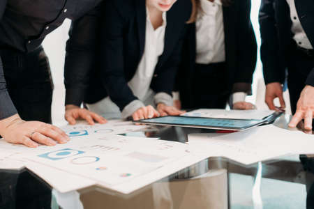 office meeting. business team brainstorming. group of workers study documents with graphs and diagrams. information analysisの写真素材