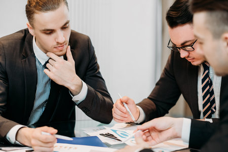 office meeting. business team brainstorming. group of workers study documents with graphs and diagrams. information analysisの写真素材