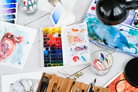 art painting inspiration creativity concept. artist creations. watercolors and drawings color and brushes scattered on the floorの写真素材