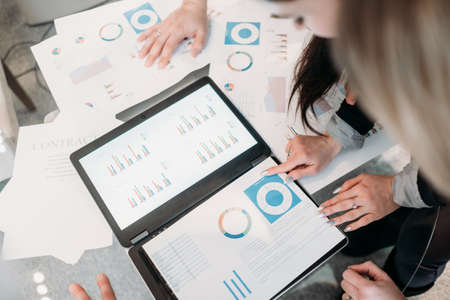 office meeting. business team brainstorming. group of workers study documents with graphs and diagrams. information analysisの写真素材