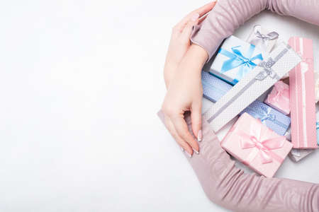 woman hugs lots of gift boxes. consumerism. present giving. holiday season goods sale discount. copyspace conceptの写真素材
