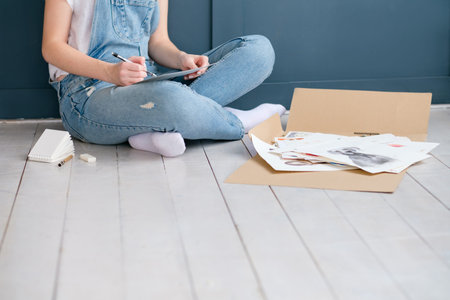 art creativity and lifestyle. drawing hobby. girl sketching a picture sitting on the floor at home.