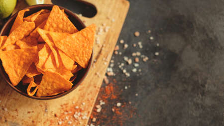 tortilla nacho chips food background. salty spicy crunchy slices in a bowl. copyspace conceptの写真素材