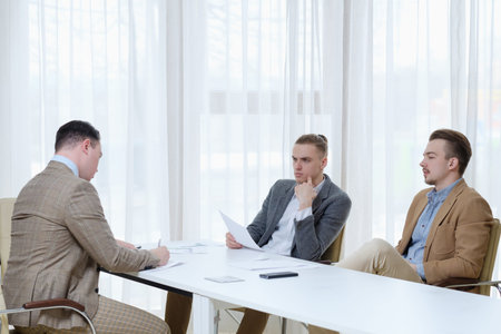 business team communication. top managers board meeting. men discussing documents in office...