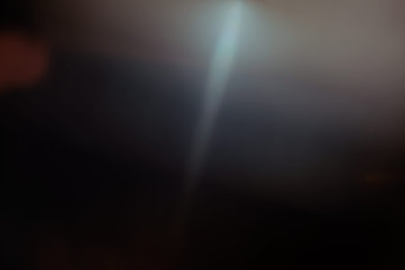 lens flare. abstract light effect. glow on black backdrop. sun rays sunlightの写真素材