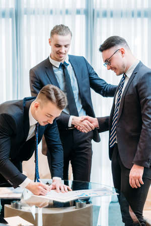 man signing contract closeup. business partnership and cooperation. deal closing and legal documents concept. job promotion, career growthの写真素材
