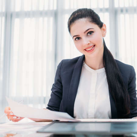 company recruiter. young professional business hr. female office manager holding a paper with resume or job application formの写真素材